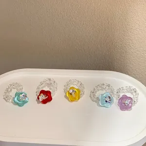 Set of five handmade beaded rings with colorful resin flower charms and crystals.