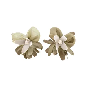 Elegant green fabric flower stud earrings featuring pearl centers and silver pins