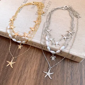 Close-up of elegant gold and silver starfish pendant layered necklaces with pearls