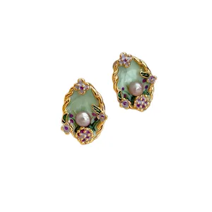 Vintage Monet style enamel flower earrings with central pearl on a pure white background