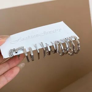 Detailed macro view of silver geometric rhinestone earring set for women's fashion