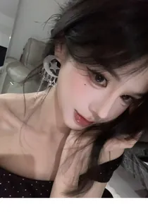 Exquisite detail view of a silver moon and star tassel earring worn by a model.