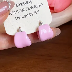 Close-up detail of pink enamel U-shaped minimalist hoop earrings with S925 silver needles