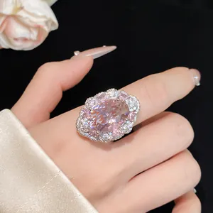 Dettaglio di un elegante anello aperto con zircone rosa ovale e halo di cristalli
