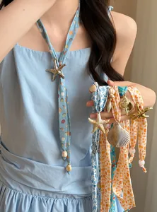 Close-up detail view of summer beach holiday necklaces with sea shell and starfish charms