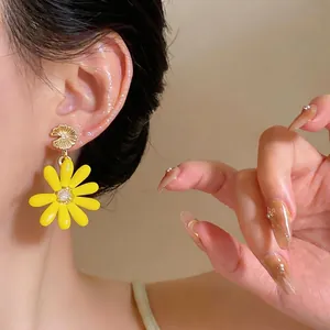 Vibrant summer style yellow daisy earrings with glass petals and silver needle post