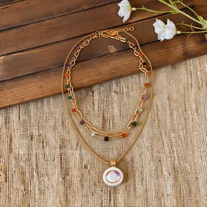 Detailed view of bohemian layered necklace with colorful beads and white pendant