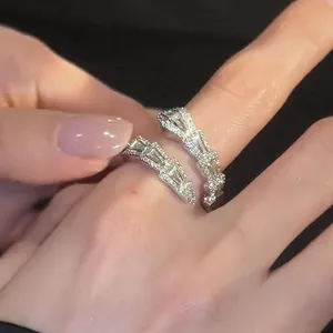 Detailed close-up of zircon-studded serpentine ring on finger showing silver finish