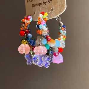 Handmade colorful crystal beaded hoop earrings with butterfly and flower charms