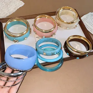Retro resin and metal bracelet set with starfish and pearl details on a display tray