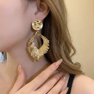 Fashionable gold pleated leaf drop earrings for women with elegant metallic texture