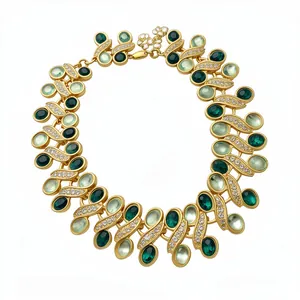 Luxurious vintage gold necklace featuring elegant green resin stones and fine rhinestones