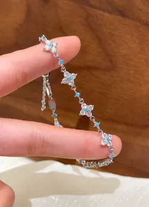 Elegant zircon flower bracelet featuring blue beads, a delicate fashion jewelry detail.