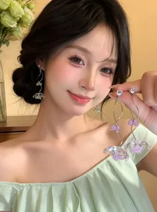 Close-up view of elegant zircon flower tassel earrings worn by a model in a lifestyle setting