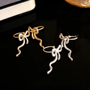 Elegant matte gold and silver bow ribbon ear cuffs designed for non-pierced ears
