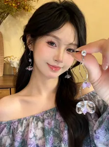 Close-up of elegant zircon flower tassel earrings on an Asian model, sweet resort style
