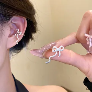 Stylish silver ribbon bow ear cuff for non-pierced ears, elegant jewelry for women