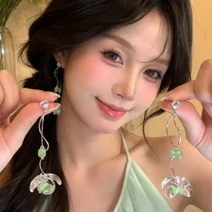 Elegant green flower tassel earrings worn by an Asian model for a sweet look
