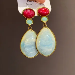 Vintage resin drop earrings with red and blue stones in a gold setting