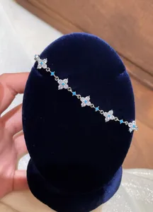 Exquisite silver-tone bracelet featuring zircon flower motifs and turquoise accents