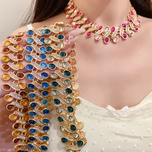 Detail view of vintage-style gold necklaces with colorful resin stones and rhinestones.