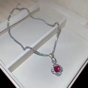 Detailed close-up of a luxury red square zircon pendant on a sparkling tennis chain.
