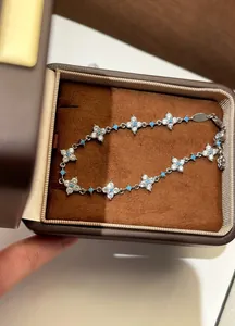Close-up of elegant zircon flower bracelet with turquoise-colored accents in a gift box