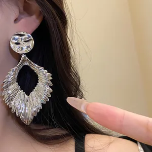 Elegant silver pleated leaf dangle earrings with a hammered metallic finish for women
