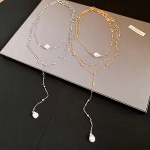 Elegant multi-layered pearl pendant Y-necklace featuring gold and silver finishes