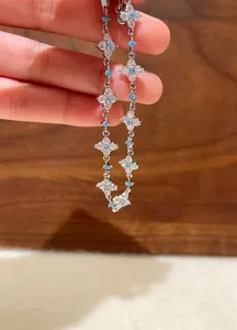Close-up of delicate flower bracelet with cubic zirconia and turquoise accents.