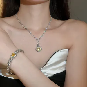 Close-up detail of a luxury yellow square zircon necklace and bracelet set on a model