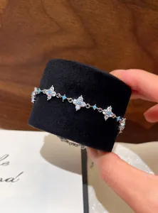 Detailed view of elegant silver bracelet featuring zircon flower motifs and turquoise beads