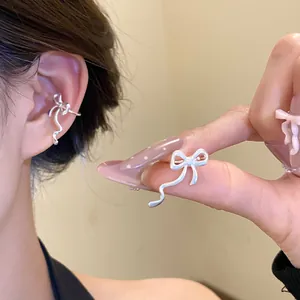 Macro view of an elegant silver bowknot ear cuff earring for women without piercings