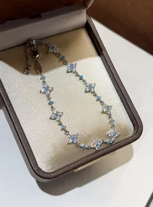 Detailed view of an elegant silver zircon flower bracelet inside a satin jewelry gift box