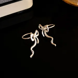 Elegant silver bowknot ear cuffs with flowing wavy tassel design for non-pierced ears