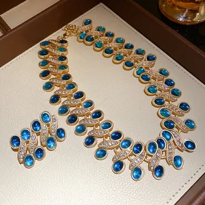 Vintage-style gold necklace and earring set with blue resin stones