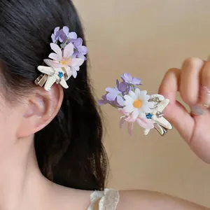 Close-up detail showing the intricate French fabric flower hair clip with starfish and pearls