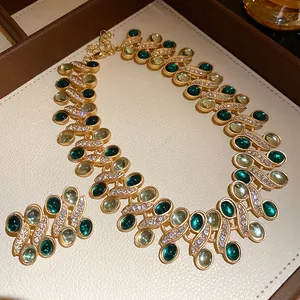Detailed macro shot of vintage gold-tone necklace and earrings set with green resin