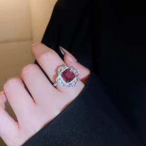Close-up of a luxury silver-toned open ring with a large square red zircon gemstone