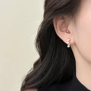 Elegant French style pearl and zircon stud earrings worn on female model's ear, S925 silver needle