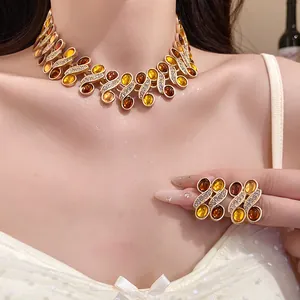 Elegant vintage amber resin and rhinestone necklace and earrings set worn by model