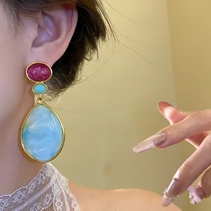Exquisite vintage resin water drop earrings featuring blue and red stones in a gold frame