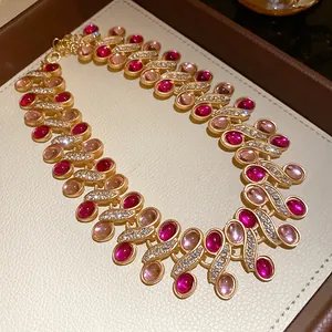Vintage gold-plated necklace featuring pink resin stones and sparkling rhinestone detail