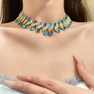 Detail view of a vintage gold choker necklace with blue resin stones and rhinestones