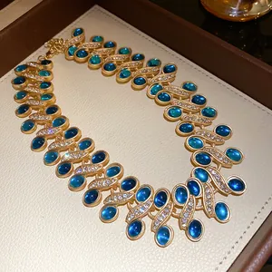 Detail of vintage gold necklace with blue resin stones and sparkling rhinestones