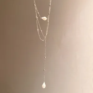 Detailed view of an elegant layered silver Y-necklace with delicate teardrop pearl pendants