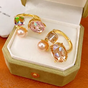 Elegant gold plated open ring featuring geometric crystals and a lustrous pink pearl