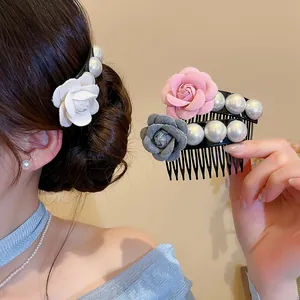 Detail view showing fabric rose and pearl hair combs in various colors