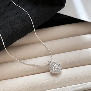 Close-up of sparkling starburst pendant necklace with cubic zirconia on elegant fabric