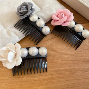 Close-up of elegant French style hair combs with fabric flowers and white pearls